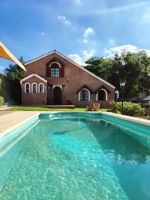 a large swimming pool in front of a house at Casa Chalet Carlos Paz in Villa Carlos Paz