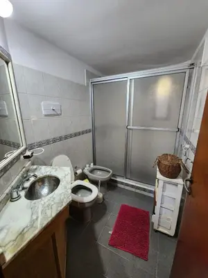 a bathroom with a sink and a toilet and a shower at Casa Chalet Carlos Paz in Villa Carlos Paz