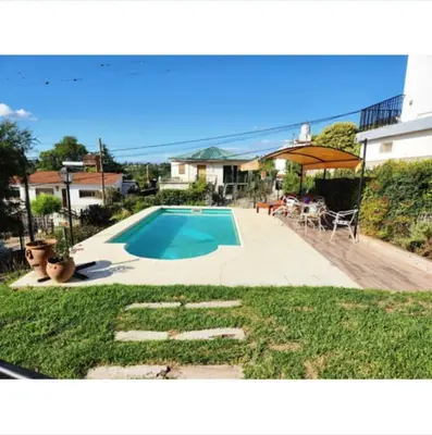 a house with a swimming pool in a yard at Casa Chalet Carlos Paz in Villa Carlos Paz