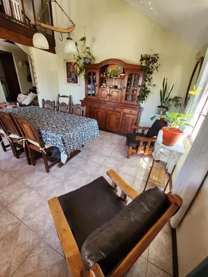 a living room with a couch and a table at Casa Chalet Carlos Paz in Villa Carlos Paz