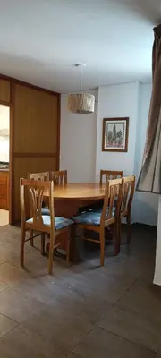 a dining room with a wooden table and chairs at Depto 2 Dormitorios en centro de Córdoba, amplio y luminoso in Cordoba