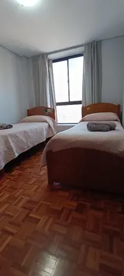 two beds in a room with a wooden floor at Depto 2 Dormitorios en centro de Córdoba, amplio y luminoso in Cordoba