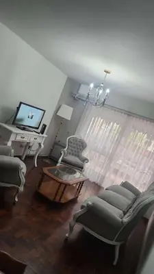 a living room with chairs and a television and a table at Departamento con Estilo centro Cordoba - Cañada y Av Colon in Cordoba