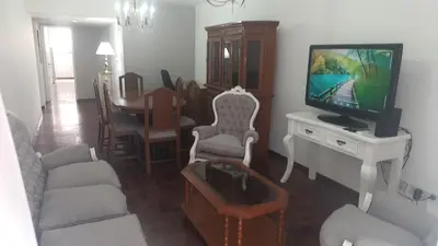a living room with a couch and a tv and a table at Departamento con Estilo centro Cordoba - Cañada y Av Colon in Cordoba