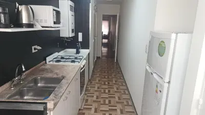 a kitchen with a sink and a stove and a refrigerator at Departamento con Estilo centro Cordoba - Cañada y Av Colon in Cordoba