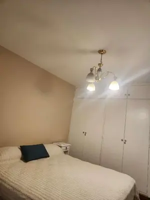 a bedroom with a bed with a blue pillow on it at Departamento con Estilo centro Cordoba - Cañada y Av Colon in Cordoba