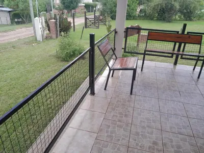 a bench sitting on a porch next to a fence at Remanso in La Estancia