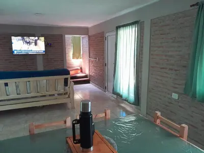 a living room with a table and a tv at Remanso in La Estancia