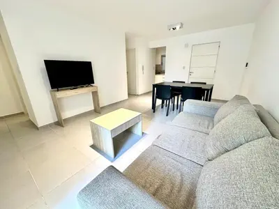 a living room with a couch and a table at Departamento Alberdi para 4 personas in Cordoba