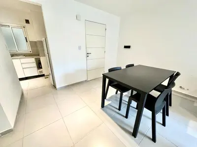 a black dining room table and chairs in a kitchen at Departamento Alberdi para 4 personas in Cordoba