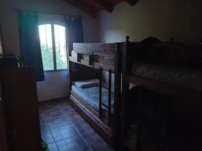 a room with two bunk beds and a window at Elsieland in Tanti