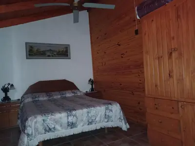 a bedroom with a bed and a wooden wall at Elsieland in Tanti
