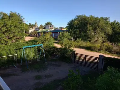 a view of a playground with a fence and a house at Elsieland in Tanti