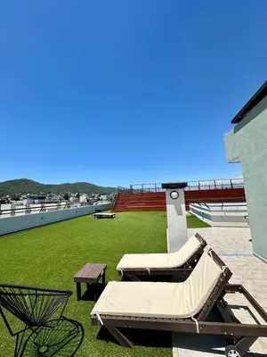 two lounge chairs and a table on a roof at Depa de Calidad en el Centro, Piscina in Villa Carlos Paz
