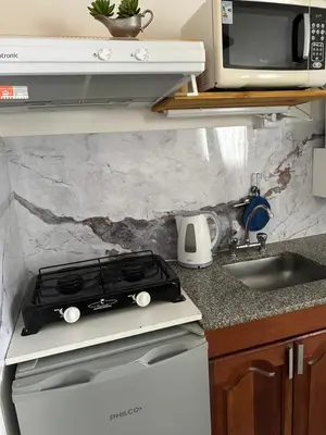 a kitchen with a stove top oven next to a sink at Apartamento Betania in Cordoba