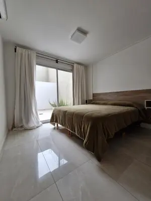 a bedroom with a bed and a large window at Brillante departamento in Cordoba