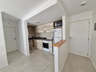 a kitchen with white cabinets and a white refrigerator at Brillante departamento in Cordoba