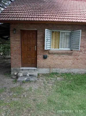 a brick house with a door and a window at Los Cachilos in Merlo