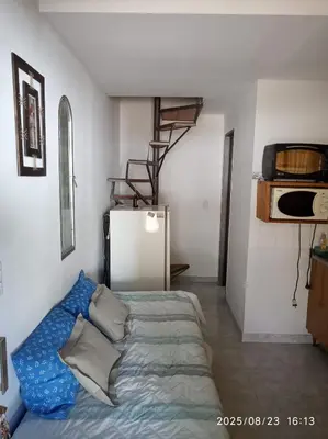 a room with a bed and a refrigerator in it at Los Cachilos in Merlo