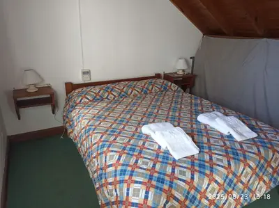 a bedroom with a bed with two towels on it at Los Cachilos in Merlo