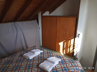 a bedroom with a bed with two towels on it at Los Cachilos in Merlo