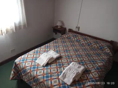 a bed with two towels on top of it at Los Cachilos in Merlo