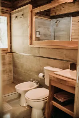 a bathroom with a toilet and a sink at La Bernardita in Villa Berna