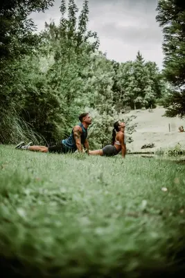 two people sitting in the grass in a field at La Bernardita in Villa Berna
