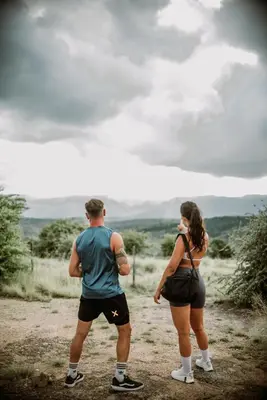 a man and a woman standing on a dirt road at La Bernardita in Villa Berna