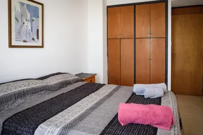 a bedroom with a bed with a pink towel on it at Depto centro 2 dorm con cochera in Cordoba