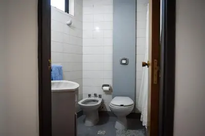 a small bathroom with a toilet and a sink at Depto centro 2 dorm con cochera in Cordoba