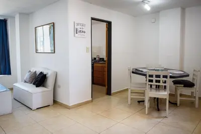 a living room with a table and a chair at Depto centro 2 dorm con cochera in Cordoba
