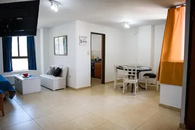 a living room with a table and a chair at Depto centro 2 dorm con cochera in Cordoba