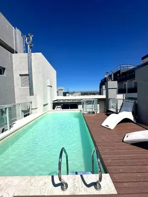 a swimming pool on the roof of a building at Depto Nuevo en el Centro, Cochera, Pile, Aire Ac in Villa Carlos Paz