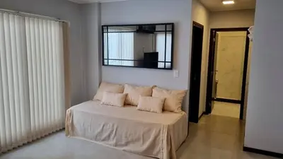 a bedroom with a bed with a mirror on the wall at Depto Nuevo en el Centro, Cochera, Pile, Aire Ac in Villa Carlos Paz