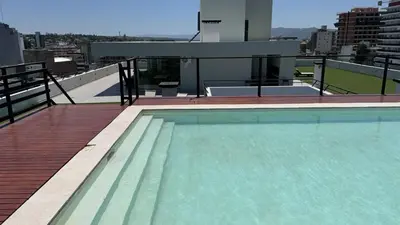 a swimming pool on the roof of a building at Departamento Paseo Cibeles in Villa Carlos Paz