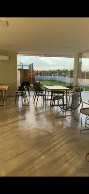 a room with tables and chairs and a large window at Departamento Paseo Cibeles in Villa Carlos Paz