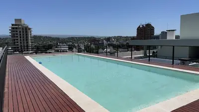 a large swimming pool on the roof of a building at Departamento Paseo Cibeles in Villa Carlos Paz