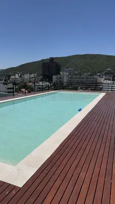 a swimming pool on the roof of a building at Departamento Paseo Cibeles in Villa Carlos Paz