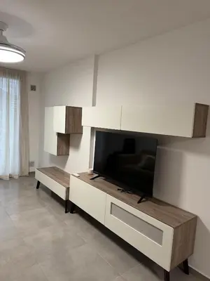 a living room with a flat screen tv on a wall at Departamento Paseo Cibeles in Villa Carlos Paz