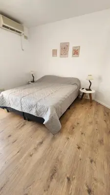a bedroom with a bed and a wooden floor at Obispo Oro Nueva Cordoba in Cordoba