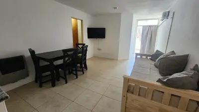 a living room with a table and a couch at Obispo Oro Nueva Cordoba in Cordoba