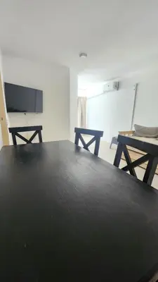 a living room with a black table and a tv at Obispo Oro Nueva Cordoba in Cordoba