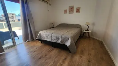 a bedroom with a bed and a large window at Obispo Oro Nueva Cordoba in Cordoba