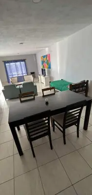 a living room with a table and chairs and a couch at Departamento 2 in Río Cuarto
