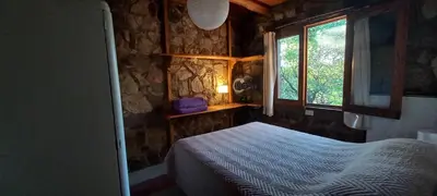 a small bedroom with a bed and a window at Casa FUJI in Villa de Las Rosas