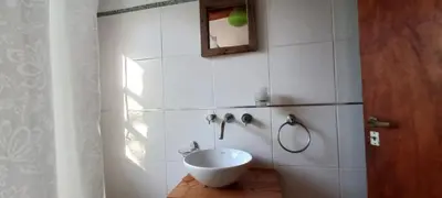 a white bathroom with a sink and a mirror at Casa FUJI in Villa de Las Rosas