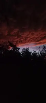 a cloudy sky with trees in the foreground at Casa FUJI in Villa de Las Rosas