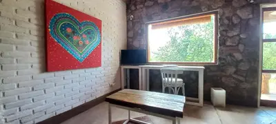 a room with a bench and a painting on the wall at Casa FUJI in Villa de Las Rosas