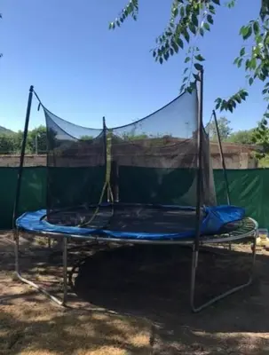a canopy bed with a net on top of it at Alquiler Temporal vacaciones in Villa Carlos Paz